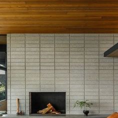 a living room filled with furniture and a fire place under a wooden ceiling mounted flat screen tv