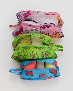 four small bags are stacked on top of each other in different colors and designs,