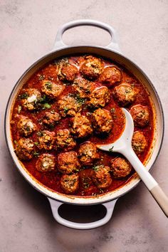 meatballs and sauce in a pot with a wooden spoon on the side, ready to be eaten