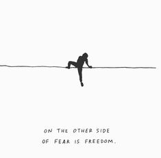 a person on a tightrope with the caption'on the other side of fear is freedom '