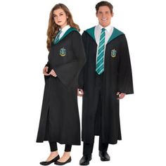 two people dressed in harry potter robes standing next to each other and posing for the camera