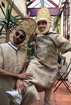 two people dressed in costumes posing for the camera