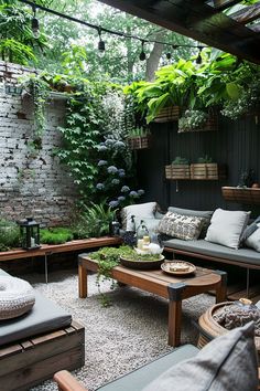 an outdoor living area with couches, tables and potted plants