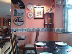 a dining room with plates on the wall