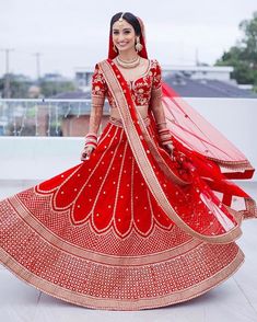 a woman in a red and gold bridal gown