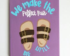 we make the perfect pair of little shoes painted on purple canvas with blue and brown lettering