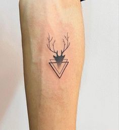 a small deer head tattoo on the leg