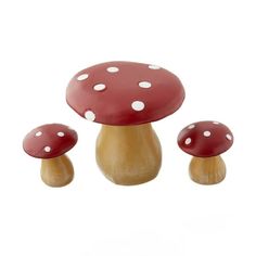 three red mushrooms with white polka dots on them are sitting in front of a white background