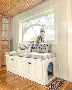 a cat sitting on top of a window sill next to a sign that says reserved for the cat