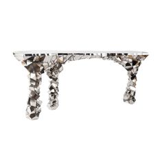 a white table topped with lots of crystal stones and hanging from it's legs