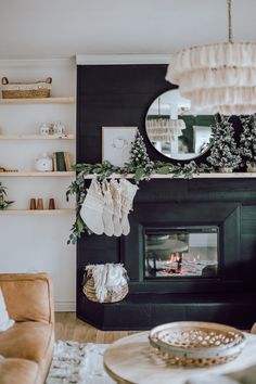 a living room filled with furniture and a fire place in front of a mirror on the wall