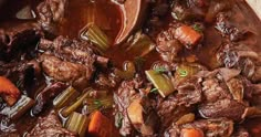 beef stew with carrots and celery in a pot