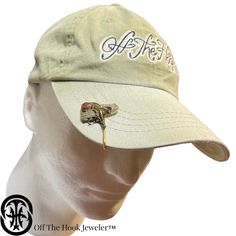 a white hat with an embroidered dragonfly on it's brimmed visor