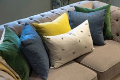 a couch with many different colored pillows on it