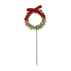 a red ribbon on top of a pin with beads and bells in the shape of a wreath