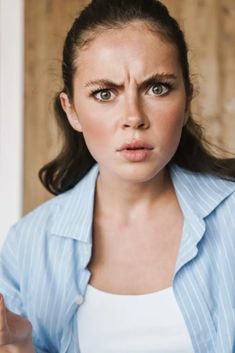 a woman making a face with her fingers