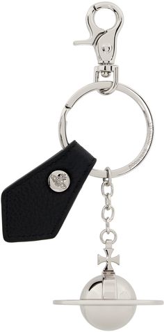 a metal key chain with a ball on it and a black tag hanging from the end