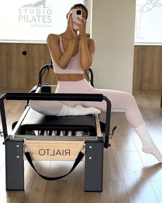 a woman taking a selfie while sitting in a chair