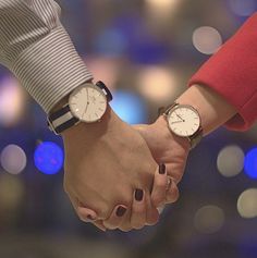 two people holding hands while standing next to each other