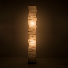 Full front view of a tall, randomly curved Japanese washi paper lamp emitting a warm glow on a dark brown background Japanese Paper Lamp, Glow Crafts, Paper Floor Lamp, Minimalist Japanese, Gifu Japan, The Lantern, Gifu, Japanese Paper, Office Room