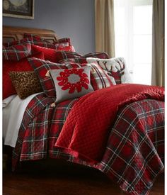 a bed with red and black plaid comforters