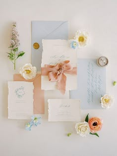 the wedding stationery is laid out on top of each other