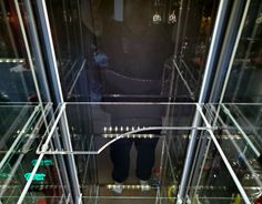 a man standing in front of a glass display case