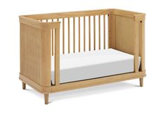 a wooden crib with a white sheet in the bottom half and side rails on each side