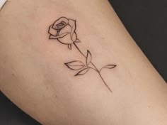 a small rose tattoo on the thigh