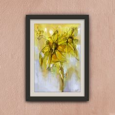 a painting of yellow flowers in a black frame hanging on a wall with a pink background