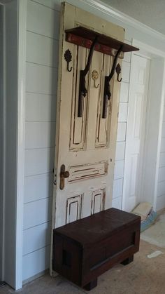 an old wooden bench sitting in front of a door