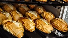 breads are lined up on racks in the oven