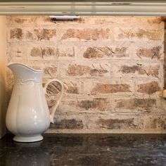 a white pitcher sitting on top of a counter