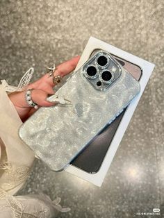 a person holding an iphone case in their hand with the cover partially open to show it's contents