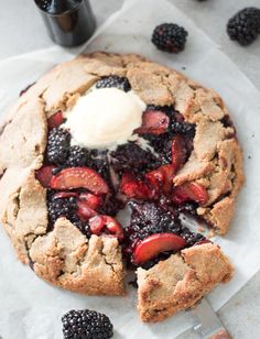 a pie with berries and ice cream on top