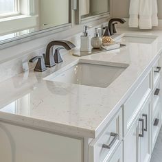 a bathroom with two sinks and mirrors in it