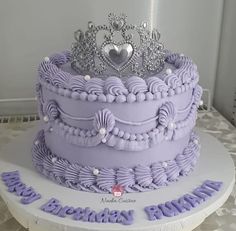 a purple cake with a tiara on top