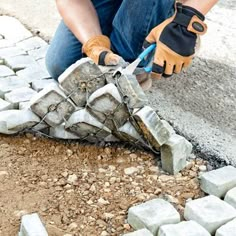 a man is working with cement on the ground