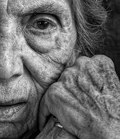 black and white photograph of an old woman's face with wrinkles on her eyes