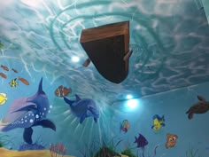 an underwater scene painted on the wall of a children's room