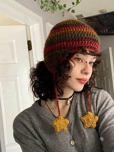 a woman wearing a knitted hat and necklace