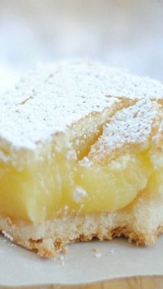 a piece of cake sitting on top of a white plate with powdered sugar on it