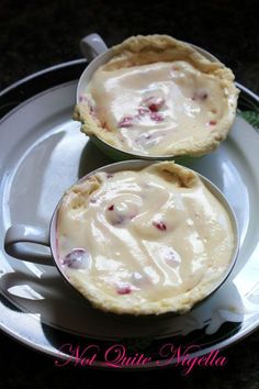 two small pies sitting on top of a white plate next to eachother