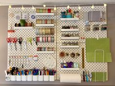 a peg board with lots of craft supplies on it