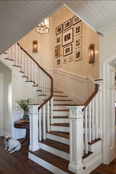 the stairs in this house are made of wood and have white balustiers on them