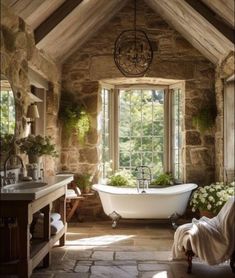 an old fashioned bathroom with stone walls and flooring is decorated in rustic style, including a claw - foot tub