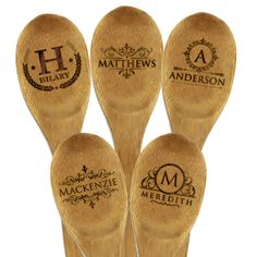 three wooden spoons with different logos on them