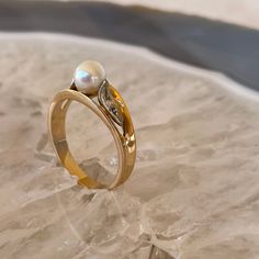 "Show your love with this sweet pearl and diamond ring in 18k gold.  The pearl is 6mm with 2 side diamonds that total .02 carats.  This sweet ring would make a lovely wedding or anniversary ring or a  \"love yourself\" ring. This ring is a size 8 1/4, is  in great vintage condition and weighs 3.4 grams." Pearl Wedding Ring, Black Hills Gold Rings, Sweet Ring, Pearl And Diamond Ring, Mother Rings, Black Hills Gold, Etsy Wedding Rings, Gold Gift, Pearl Wedding