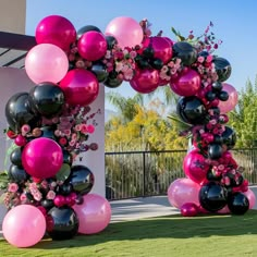 an arch made out of balloons and flowers