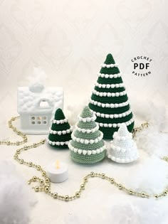 crocheted christmas trees and candles on a white background